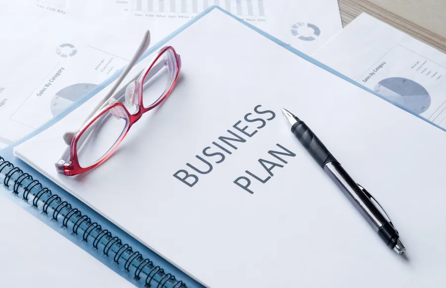 business plan documents and pen