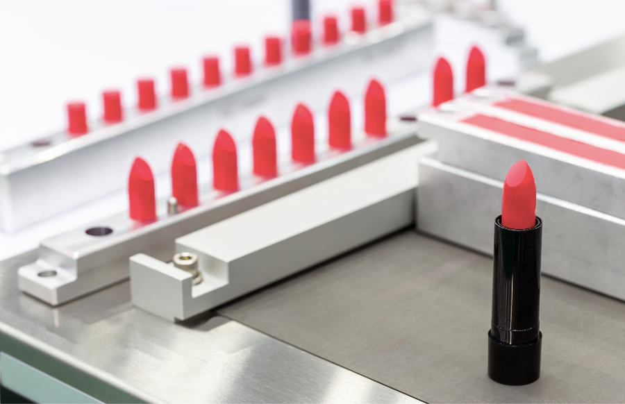 A lipstick vial filling machine in a cosmetic factory
