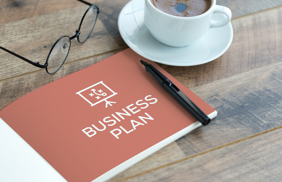 eye glasses, coffee and business plan in wood table