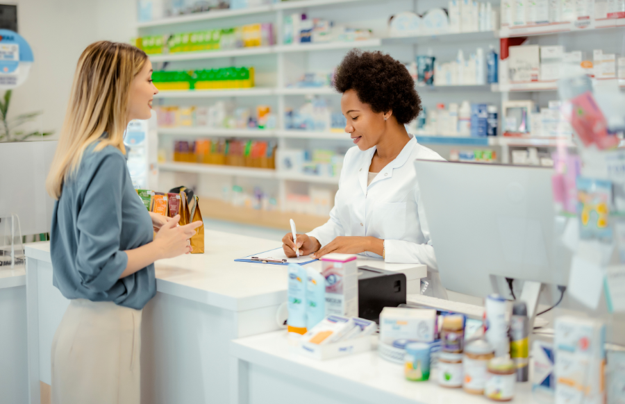 a pharmacist assisting a female client in the counter
