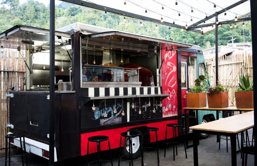 food truck on the street with chairs and tables for dine in